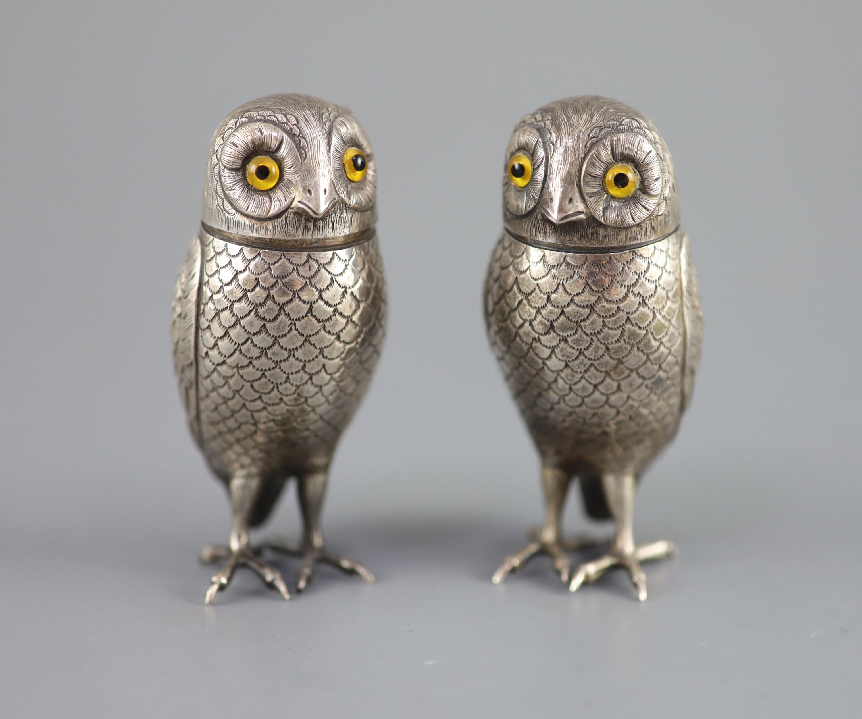 A pair of late 19th/early 20th century Dutch silver novelty pepperettes, modelled as owls